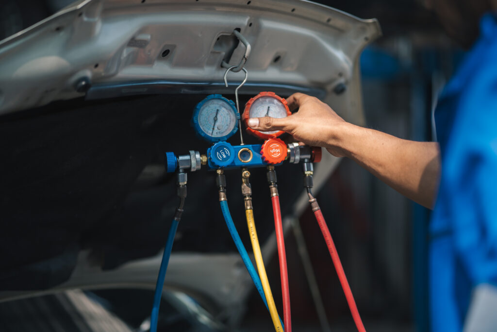 hand of car mechanic technician use meter to check 2023 11 27 04 57 07 utc scaled